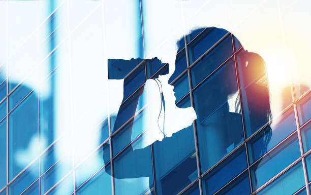 Businessman looks far for new job opportunities with binoculars. double exposure
